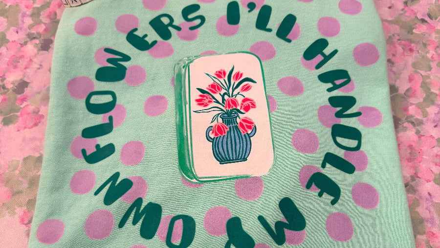 Tile with floral design and text on a dot background